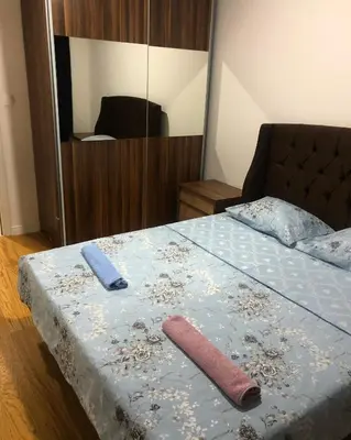 a bedroom with a bed with two towels on it at Stan Central point Podgorica in Podgorica