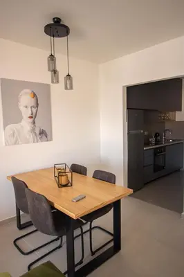 a dining room with a wooden table and chairs at Vertmont Villa in Sveti Stefan