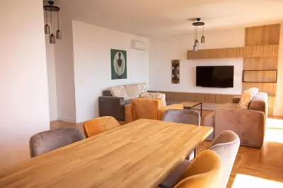 a living room with a wooden table and chairs at Vertmont Villa in Sveti Stefan