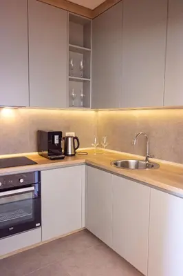 a kitchen with white cabinets and a sink at Vertmont Villa in Sveti Stefan