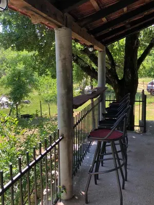 a row of benches sitting next to a fence at Bandici house in Podgorica