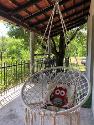 a pillow sitting on a swing in a porch at Bandici house in Podgorica