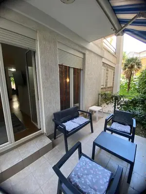 two chairs and a table on a patio at apartman Natali in Budva