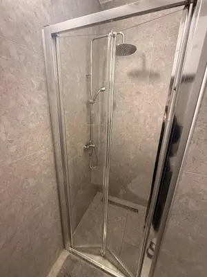 a shower stall with a glass door in a bathroom at apartman Natali in Budva