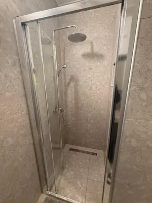 a shower with a glass door in a bathroom at apartman Natali in Budva