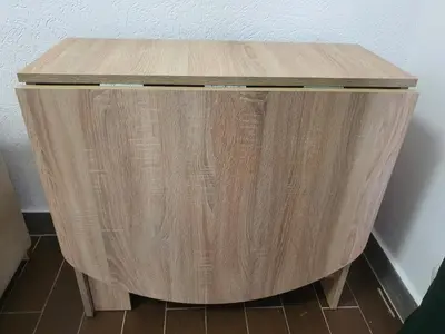 a wooden side table in the corner of a room at Darin in Budva