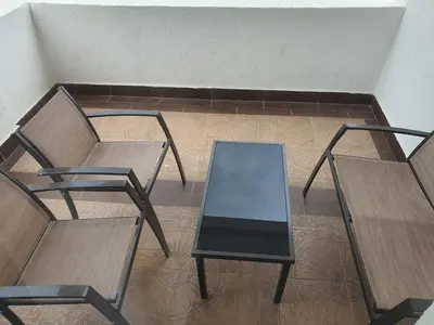 two chairs and a glass table in a room at Darin in Budva