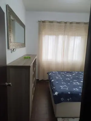 a bedroom with a bed and a dresser and a mirror at Darin in Budva