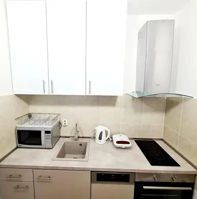 a kitchen with a sink and a microwave at Becici Studio Apartment in Budva