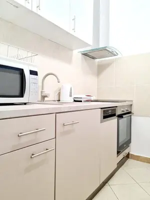 a kitchen with a microwave and a sink at Becici Studio Apartment in Budva