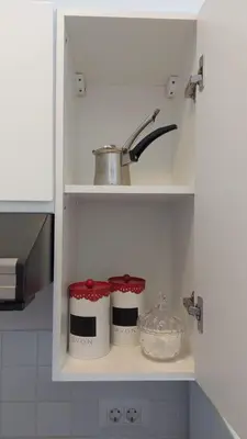a kitchen shelf with two jars and a sink at Lijepo pozicioniran stan, atrakcije blizu in Podgorica