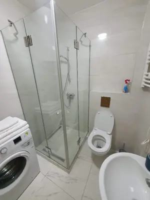 a bathroom with a shower and a toilet and a sink at Lijepo pozicioniran stan, atrakcije blizu in Podgorica