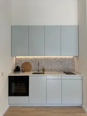 a kitchen with white cabinets and a sink at Point of View in Kotor