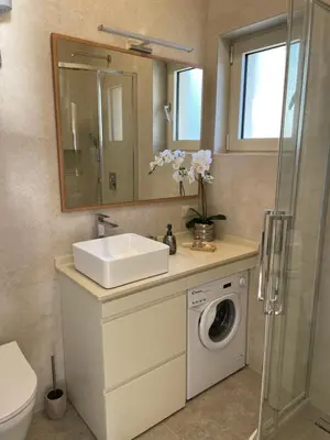 a bathroom with a sink and a washing machine at Point of View in Kotor