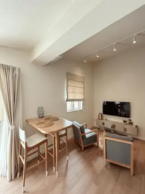 a living room with a table and chairs and a television at Point of View in Kotor