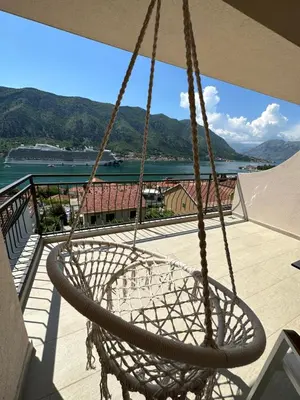 a swing on a balcony with a view of the water at Point of View in Kotor