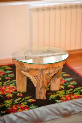 a wooden table with a glass top on a rug at Forest house in Cetinje