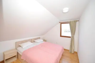 a bedroom with a pink bed and a window at Filipa River House Ada Bojana in Ulcinj