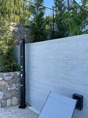 a white toilet sitting next to a fence at Villa Pine in Bar
