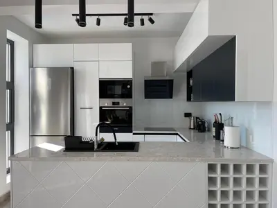 a kitchen with a sink and a stainless steel refrigerator at Villa Pine in Bar
