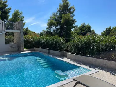 a swimming pool in a backyard with a patio furniture and sidx sidx at Villa Pine in Bar