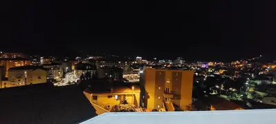 a view of a city at night with lights at Dream Studio in Budva