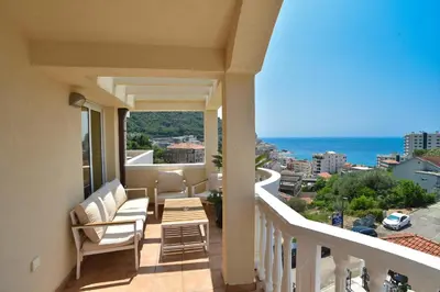 a balcony with chairs and a view of the ocean at Apartmani Bojana in Budva