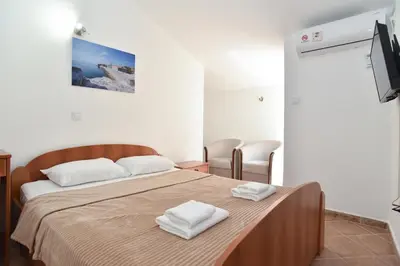 a bedroom with a bed with two towels on it at Apartmani Bojana in Budva