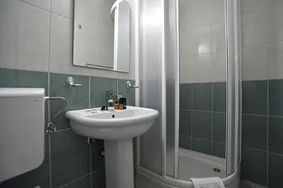 a bathroom with a sink and a shower at Apartmani Bojana in Budva