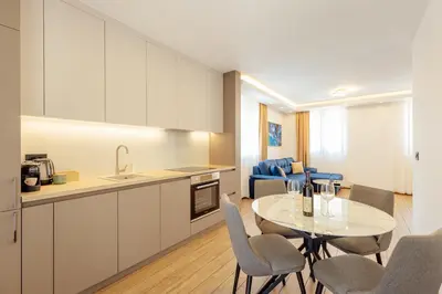 a kitchen and dining room with a table and chairs at Villa Elle in Kotor