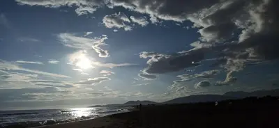 a beach with a cloudy sky and the ocean at Lemon Tree in Ulcinj