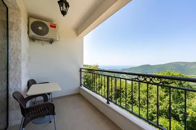 a balcony with a table and chairs and a view at Villa Andrea 1 in Budva