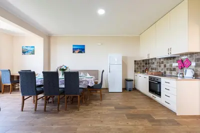 a kitchen and dining room with a table and chairs at Villa Andrea 1 in Budva