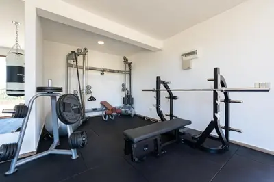 a gym with weights and tread machines in a room at Villa Andrea 1 in Budva