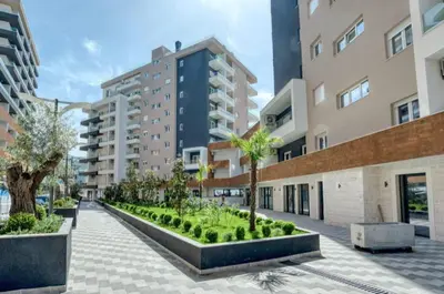 a courtyard in a building with palm trees and buildings at Apartment Queen Milena in Budva
