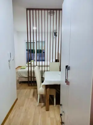 a room with a table and chairs and a bed at Apartment Queen Milena in Budva