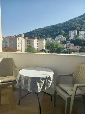 a table and chairs on a balcony with a view at Apartment Queen Milena in Budva