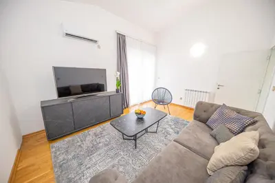 a living room with a couch and a tv at Sotto Sole apartment in Bar