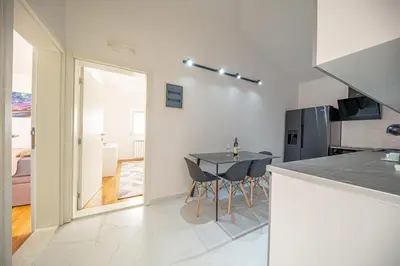 a kitchen with a table and chairs in a room at Sotto Sole apartment in Bar
