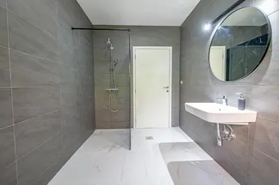 a bathroom with a shower and a sink and a mirror at Sotto Sole apartment in Bar