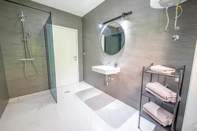 a bathroom with a shower and a sink and a mirror at Sotto Sole apartment in Bar