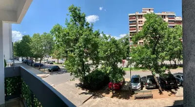 a view of a parking lot with trees and cars at Old town in Podgorica