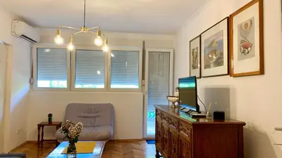 a living room with a desk with a computer and a chair at Old town in Podgorica