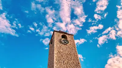 a tall clock tower with a blue sky with clouds at Old town in Podgorica