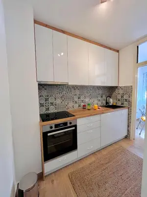 a kitchen with white cabinets and a stove at Old town in Podgorica