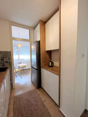 a kitchen with a refrigerator and a dining room at Old town in Podgorica