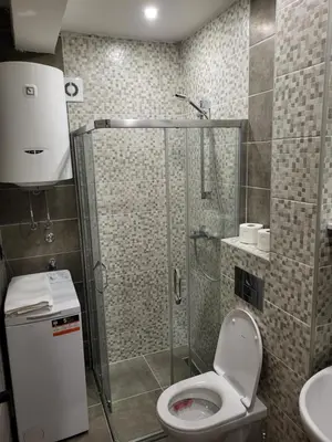a bathroom with a shower and a toilet and a sink at Lux Apartmani Bajova in Cetinje