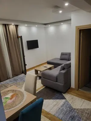 a living room with a couch and a table at Lux Apartmani Bajova in Cetinje