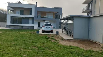 a white car parked in front of a house at Villa MERKURY in Sutomore
