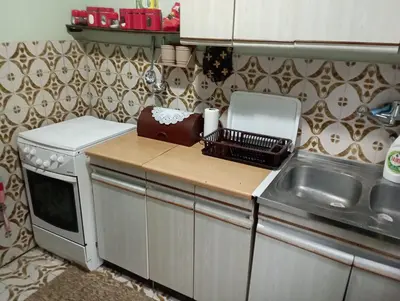 a kitchen with a counter with a sink and a microwave at Kaldrmica in Gornji Brčeli